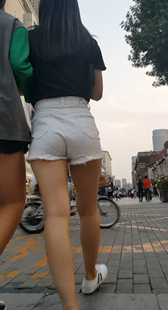 街拍逛街的白色短裤长发美眉包翘臀